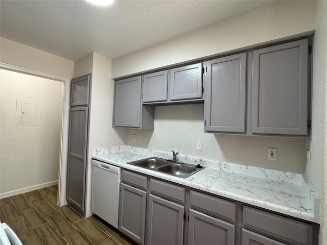 6500 Sands Point Dr Unit 114, Houston, TX 77074 - kitchen with a sink, gray cabinets, dishwashing machine, light countertops, and dark wood-style floors