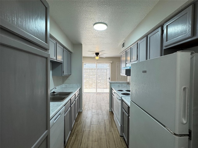 6500 Sands Point Dr Unit 114, Houston, TX 77074 - kitchen featuring white appliances, a textured ceiling, ceiling fan, light countertops, and gray cabinetry
