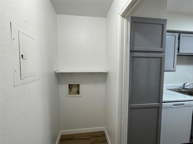 6500 Sands Point Dr Unit 114, Houston, TX 77074 - laundry room with electric panel, washer hookup, baseboards, and dark wood-style flooring