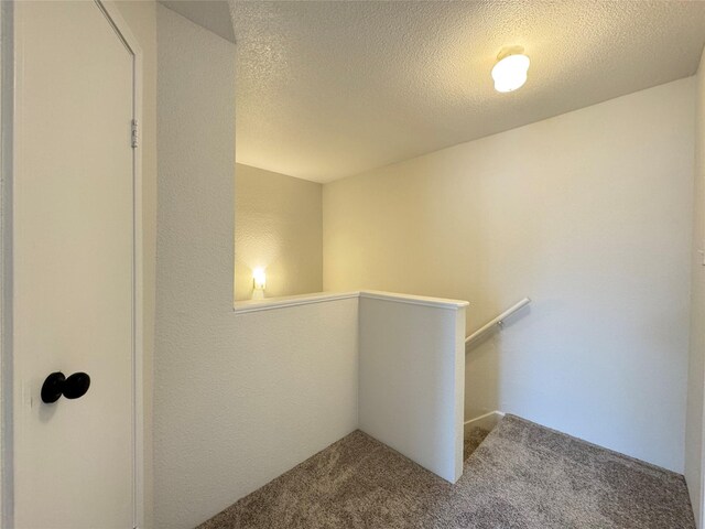 6500 Sands Point Dr Unit 114, Houston, TX 77074 - hallway with an upstairs landing, carpet, and a textured ceiling