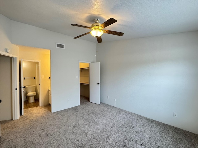 6500 Sands Point Dr Unit 114, Houston, TX 77074 - unfurnished bedroom featuring carpet flooring, a walk in closet, ensuite bath, a closet, and ceiling fan