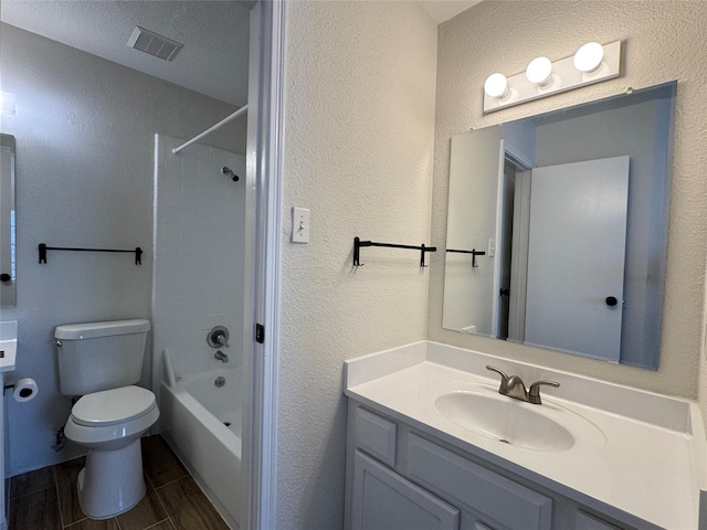 6500 Sands Point Dr Unit 114, Houston, TX 77074 - bathroom featuring vanity, toilet, a textured wall, and bathing tub / shower combination