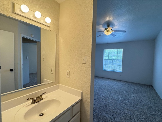 6500 Sands Point Dr Unit 114, Houston, TX 77074 - bathroom featuring a textured wall, a ceiling fan, and vanity