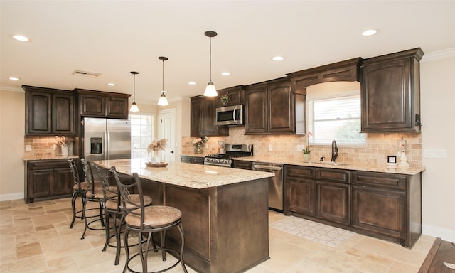 4903 Meadow Ln, Dickinson, TX 77539 - kitchen with stainless steel appliances, a sink, dark brown cabinets, crown molding, and recessed lighting