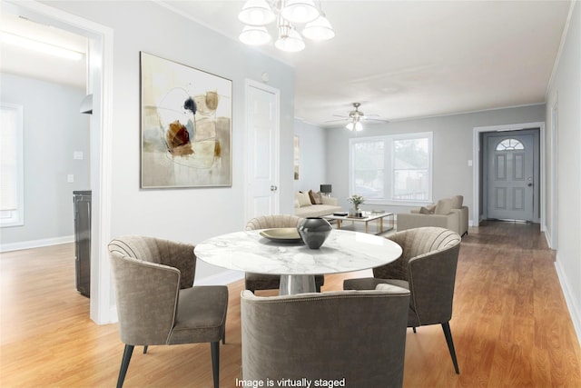 4514 Keystone St, Houston, TX 77021 - dining space with light wood finished floors, baseboards, ceiling fan, and a chandelier