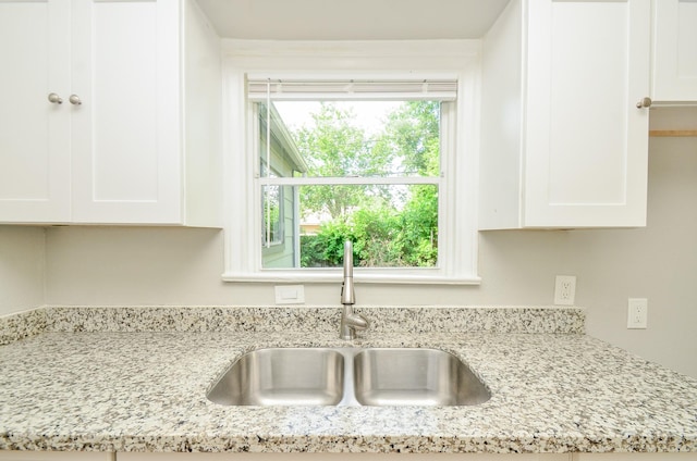 4514 Keystone St, Houston, TX 77021 - kitchen view of a sink, white cabinets, and light stone counters