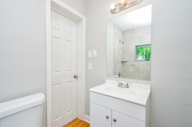 4514 Keystone St, Houston, TX 77021 - bathroom with toilet, vanity, and wood finished floors