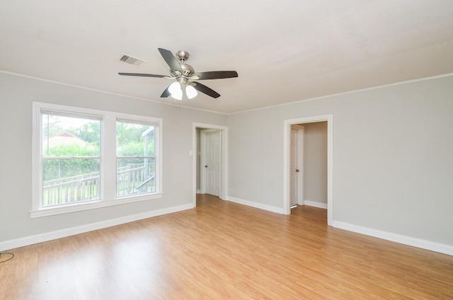 4514 Keystone St, Houston, TX 77021 - empty room with light wood finished floors, ceiling fan, baseboards, and ornamental molding