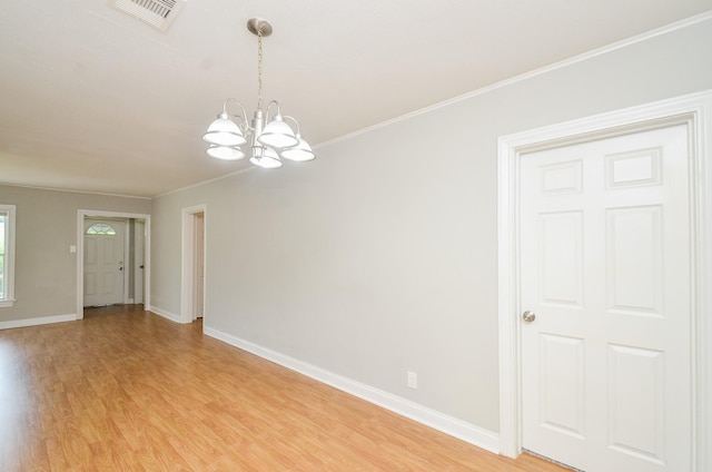 4514 Keystone St, Houston, TX 77021 - empty room featuring light wood finished floors, a chandelier, baseboards, and crown molding