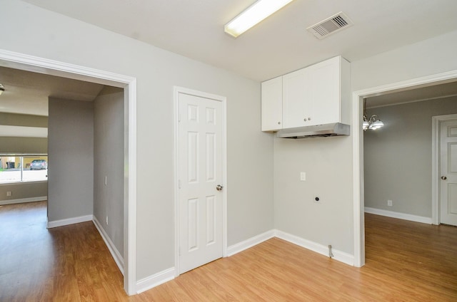 4514 Keystone St, Houston, TX 77021 - washroom with light wood-style floors, electric dryer hookup, and baseboards
