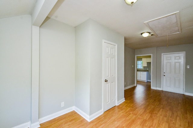 4514 Keystone St, Houston, TX 77021 - empty room with attic access, light wood-style flooring, and baseboards