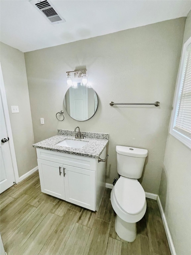105 Cornelia St, Sweeny, TX 77480 - bathroom featuring wood finished floors, vanity, baseboards, and toilet