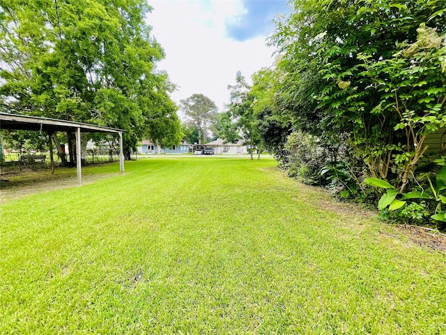 105 Cornelia St, Sweeny, TX 77480 - view of green lawn featuring a carport