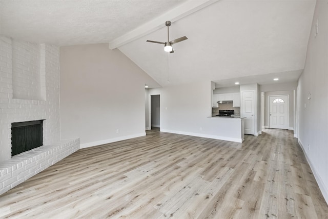 12523 Drifting Winds Dr, Houston, TX 77044 - unfurnished living room featuring beam ceiling, light wood-style floors, baseboards, ceiling fan, and a brick fireplace