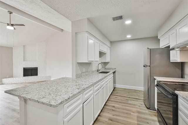 12523 Drifting Winds Dr, Houston, TX 77044 - kitchen with a sink, black range with electric stovetop, light wood-style flooring, white cabinets, and a peninsula
