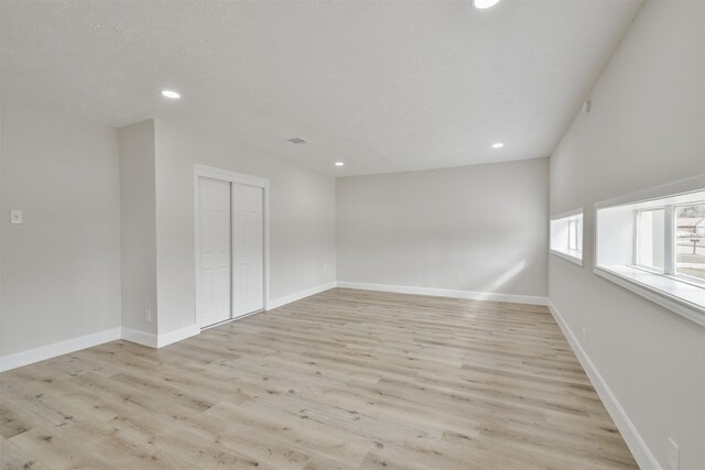 12523 Drifting Winds Dr, Houston, TX 77044 - empty room with recessed lighting, light wood finished floors, and baseboards