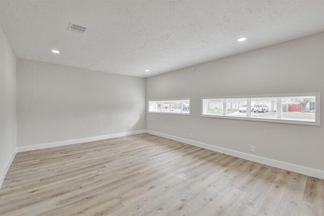 12523 Drifting Winds Dr, Houston, TX 77044 - empty room featuring wood finished floors, baseboards, recessed lighting, and a textured ceiling
