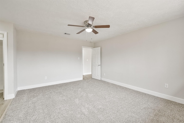 12523 Drifting Winds Dr, Houston, TX 77044 - spare room with baseboards, ceiling fan, a textured ceiling, and light colored carpet