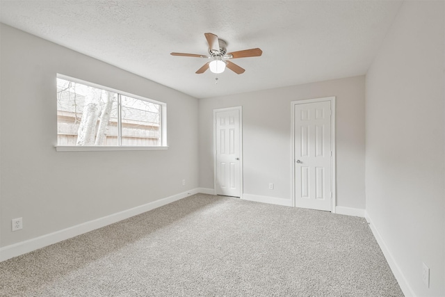 12523 Drifting Winds Dr, Houston, TX 77044 - unfurnished bedroom featuring carpet floors, two closets, baseboards, and ceiling fan