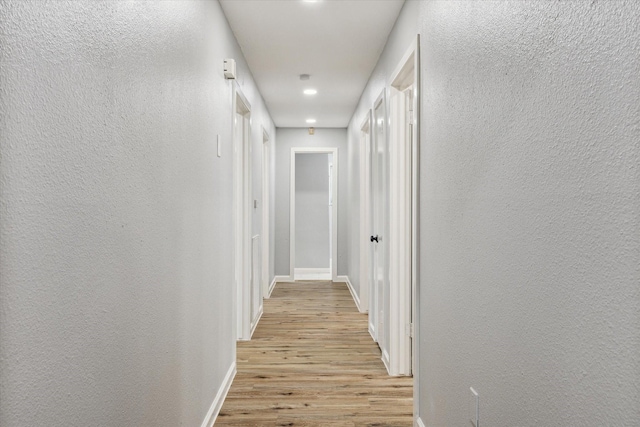 1301 Gulf St, Pasadena, TX 77502 - corridor with light wood-style flooring, baseboards, a textured wall, and recessed lighting