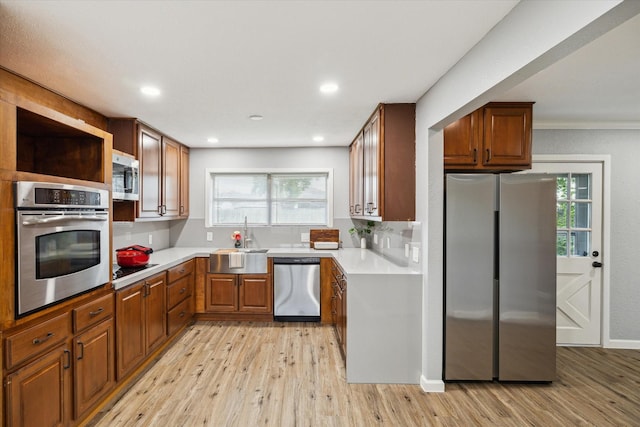 1301 Gulf St, Pasadena, TX 77502 - kitchen with stainless steel appliances, a sink, light wood-style floors, healthy amount of natural light, and recessed lighting