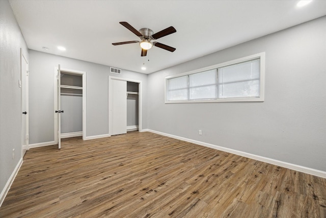 1301 Gulf St, Pasadena, TX 77502 - unfurnished bedroom featuring multiple closets, baseboards, wood finished floors, and recessed lighting