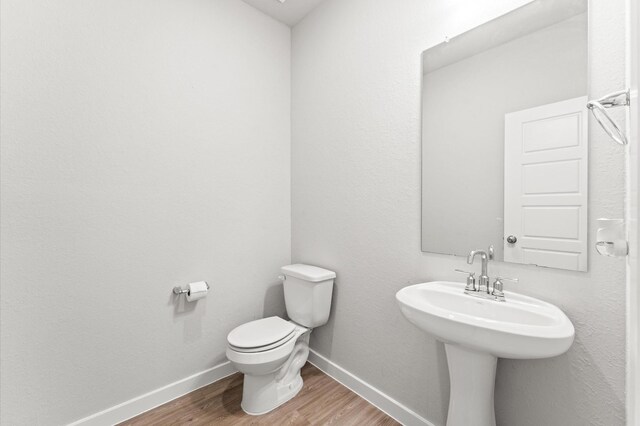 818 Deerhurst Ln, Magnolia, TX 77354 - bathroom featuring wood finished floors and toilet