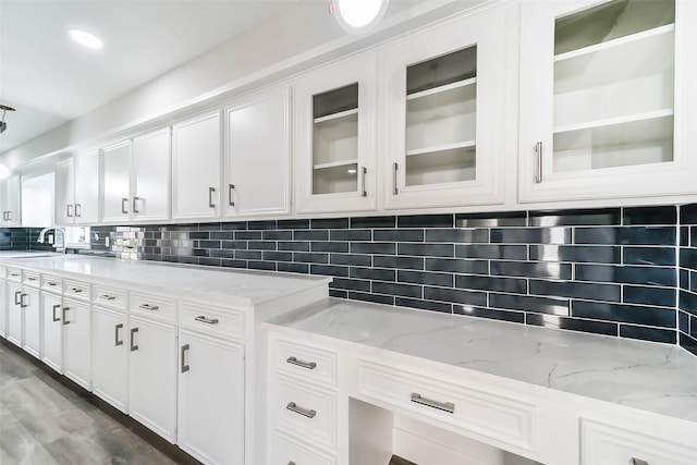3522 Creekbriar Dr, Houston, TX 77068 - kitchen featuring a sink, white cabinetry, tasteful backsplash, and light stone counters