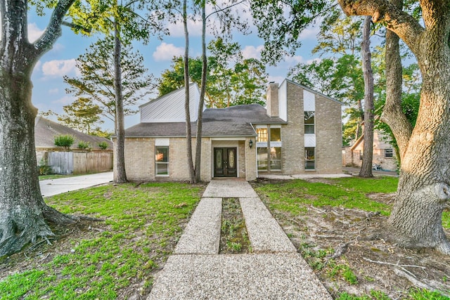 3522 Creekbriar Dr, Houston, TX 77068 - mid-century inspired home featuring french doors, brick siding, a chimney, and a shingled roof