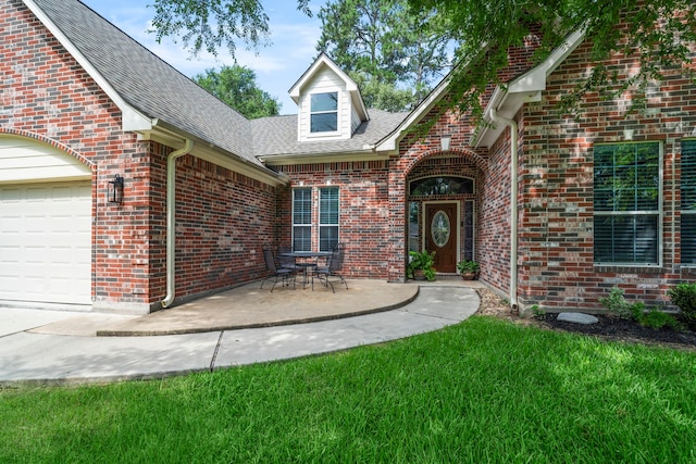 15 Rose Pine Ct, Magnolia, TX 77355 - view of exterior entry with brick siding, a shingled roof, and an attached garage