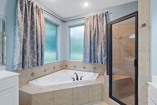 15 Rose Pine Ct, Magnolia, TX 77355 - bathroom with vanity, a garden tub, a stall shower, and healthy amount of natural light