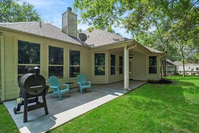 15 Rose Pine Ct, Magnolia, TX 77355 - rear view of house featuring a yard, a patio, a chimney, and a shingled roof
