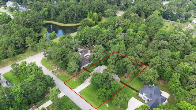 15 Rose Pine Ct, Magnolia, TX 77355 - aerial view of property's location with a nearby body of water, property boundaries highlighted, and a heavily wooded area