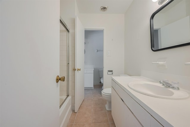 6103 Fondren Rd Unit 7, Houston, TX 77036 - bathroom with toilet, vanity, tile patterned floors, and shower / bath combination with glass door