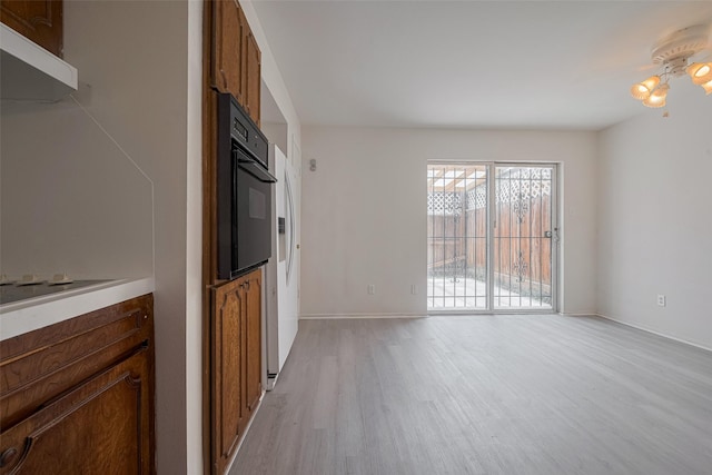 6103 Fondren Rd Unit 7, Houston, TX 77036 - unfurnished living room featuring light wood-type flooring and baseboards