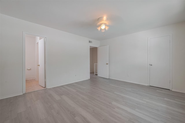 6103 Fondren Rd Unit 7, Houston, TX 77036 - unfurnished bedroom featuring light wood finished floors, ensuite bath, and baseboards