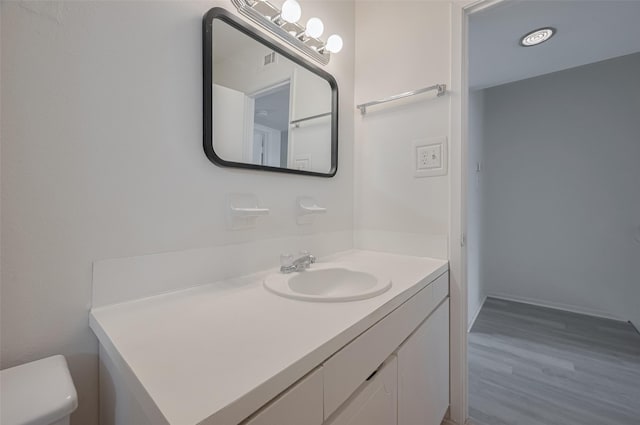 6103 Fondren Rd Unit 7, Houston, TX 77036 - bathroom with vanity, wood finished floors, and toilet