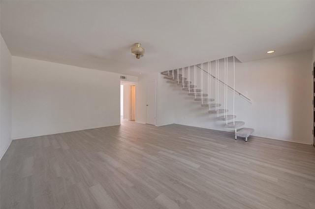 6103 Fondren Rd Unit 7, Houston, TX 77036 - unfurnished living room featuring stairway, wood finished floors, and recessed lighting