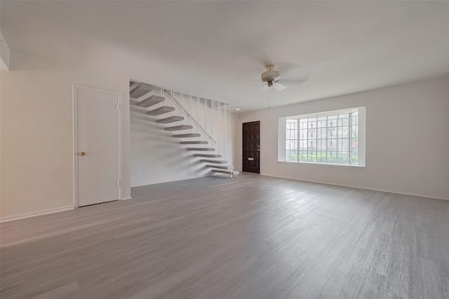 6103 Fondren Rd Unit 7, Houston, TX 77036 - unfurnished living room featuring stairway, ceiling fan, wood finished floors, and baseboards