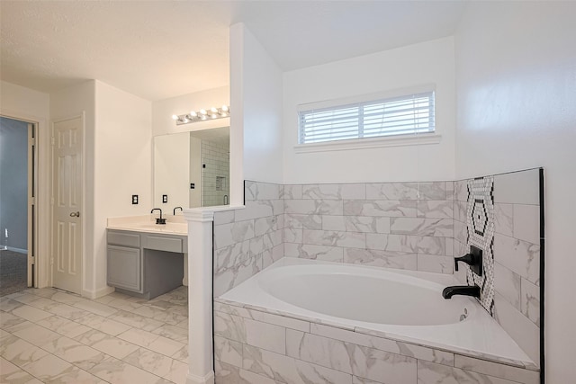 5011 Bridgecrossing Ct, Spring, TX 77379 - bathroom with a garden tub, vanity, and marble finish floors