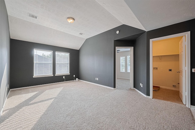 5011 Bridgecrossing Ct, Spring, TX 77379 - unfurnished bedroom featuring carpet, lofted ceiling, a textured ceiling, and baseboards