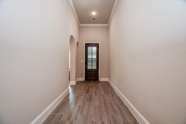 2334 Twin Rose Dr, Missouri City, TX 77459 - doorway to outside featuring arched walkways, ornamental molding, baseboards, and wood finished floors