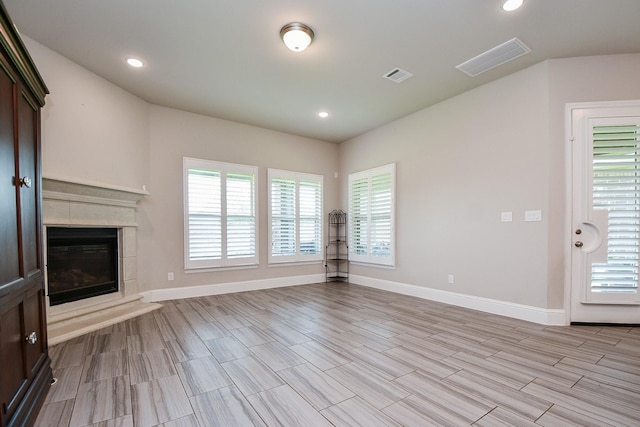 2334 Twin Rose Dr, Missouri City, TX 77459 - unfurnished living room with baseboards, a tile fireplace, recessed lighting, and wood tiled floors
