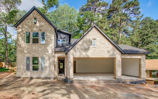 1802 Rollingwood Dr, Huntsville, TX 77340 - view of front of home featuring a garage, concrete driveway, brick siding, and roof with shingles