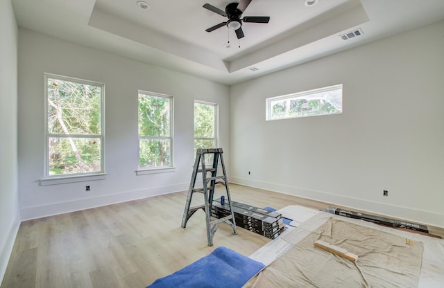 1802 Rollingwood Dr, Huntsville, TX 77340 - workout area with a raised ceiling, light wood finished floors, a ceiling fan, and baseboards