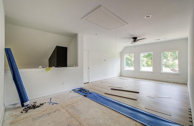 1802 Rollingwood Dr, Huntsville, TX 77340 - unfurnished living room with attic access, vaulted ceiling, and baseboards