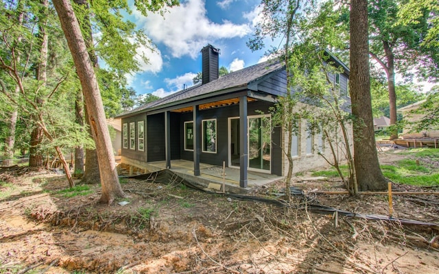 1802 Rollingwood Dr, Huntsville, TX 77340 - rear view of house featuring a chimney and a patio area