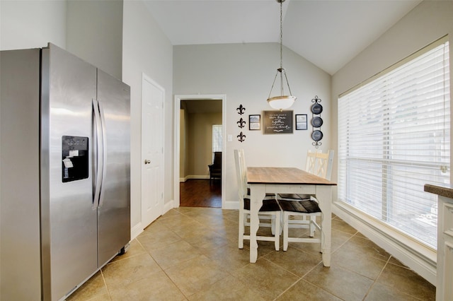 26622 Clear Mill Ln, Katy, TX 77494 - dining space featuring lofted ceiling, light tile patterned floors, plenty of natural light, and baseboards
