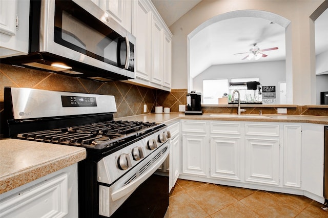 26622 Clear Mill Ln, Katy, TX 77494 - kitchen featuring appliances with stainless steel finishes, arched walkways, lofted ceiling, a sink, and a ceiling fan