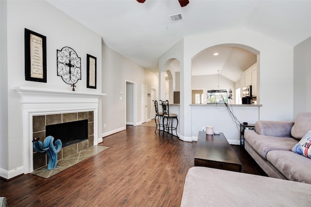 26622 Clear Mill Ln, Katy, TX 77494 - living room featuring lofted ceiling, dark wood finished floors, ceiling fan, arched walkways, and a fireplace